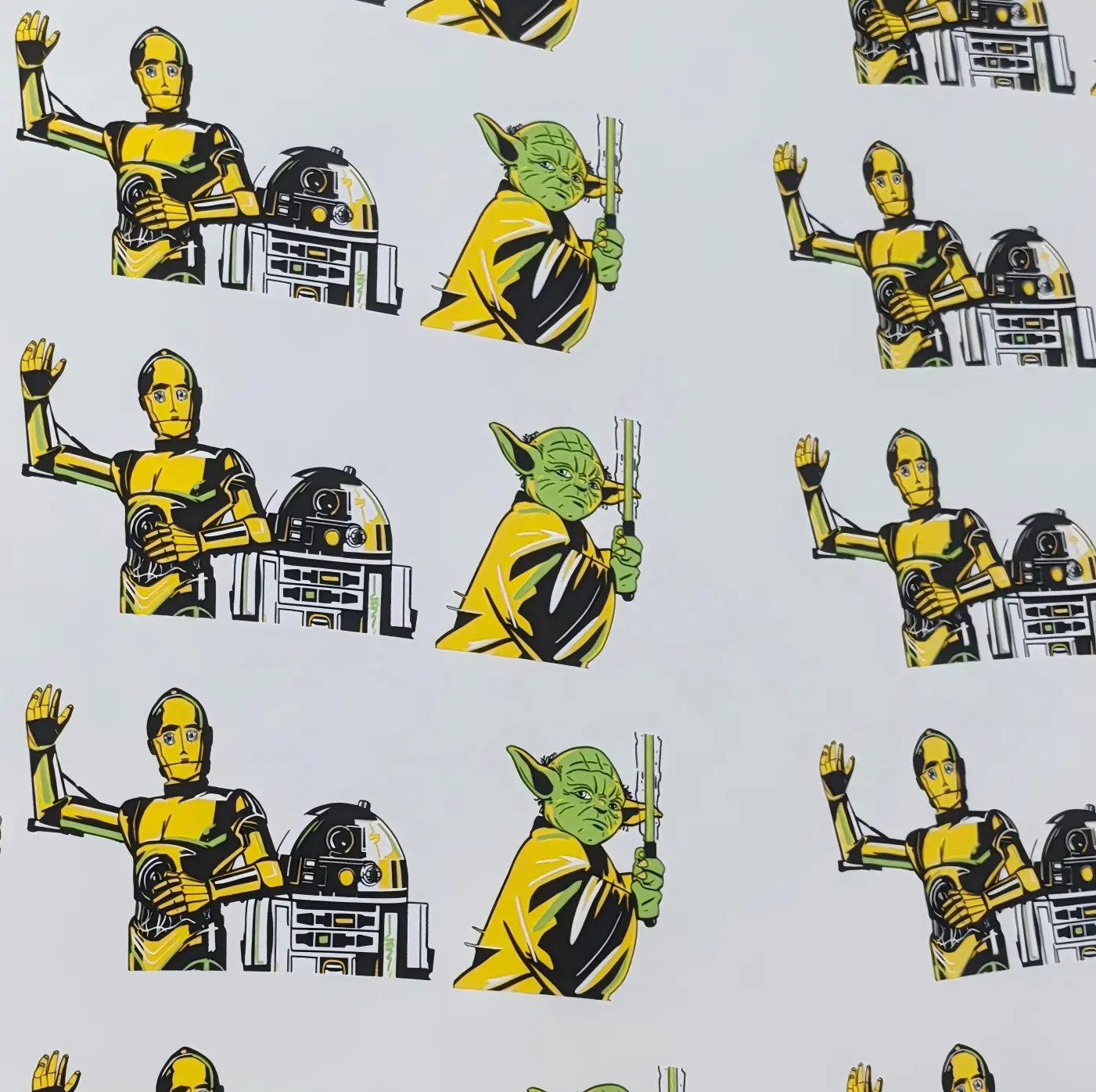 Printed waterslide decal samples — yellow-and-black robots and green character figures repeated on white backing paper